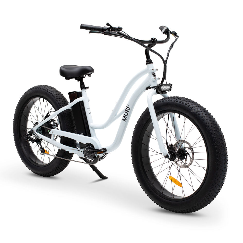A step-through electric fat bike in white color with fat tires and a control screen on the handlebars.