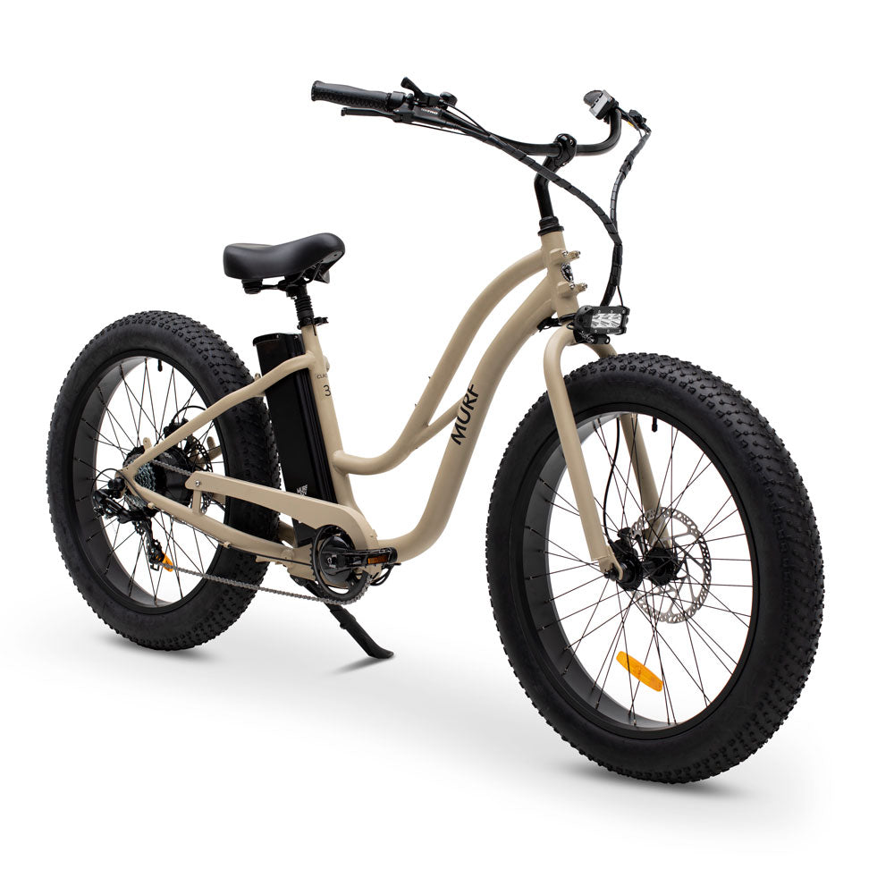 A step-through electric fat bike in beige color with fat tires and a control screen on the handlebars.