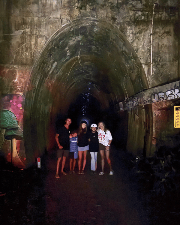 Family at the entrance of the glow worm tunnel on the Northern Rivers Rail Trail